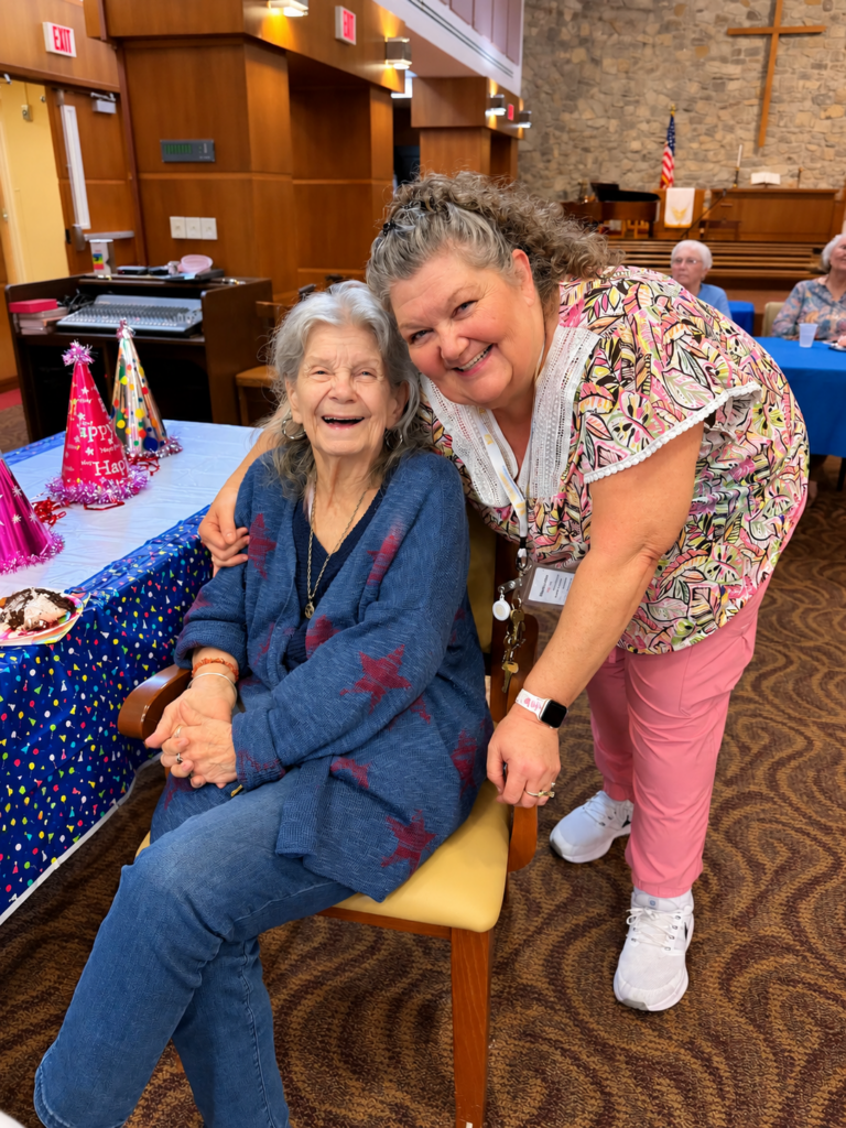 Resident smiling with a team member during a community celebration at The McKendree in Hermitage, Tennessee