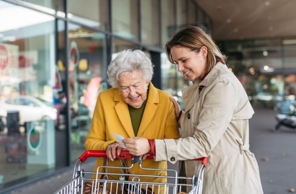 An adult child helps their senior parent with dementia with groceries, as it gets more difficult as Alzheimer’s progresses