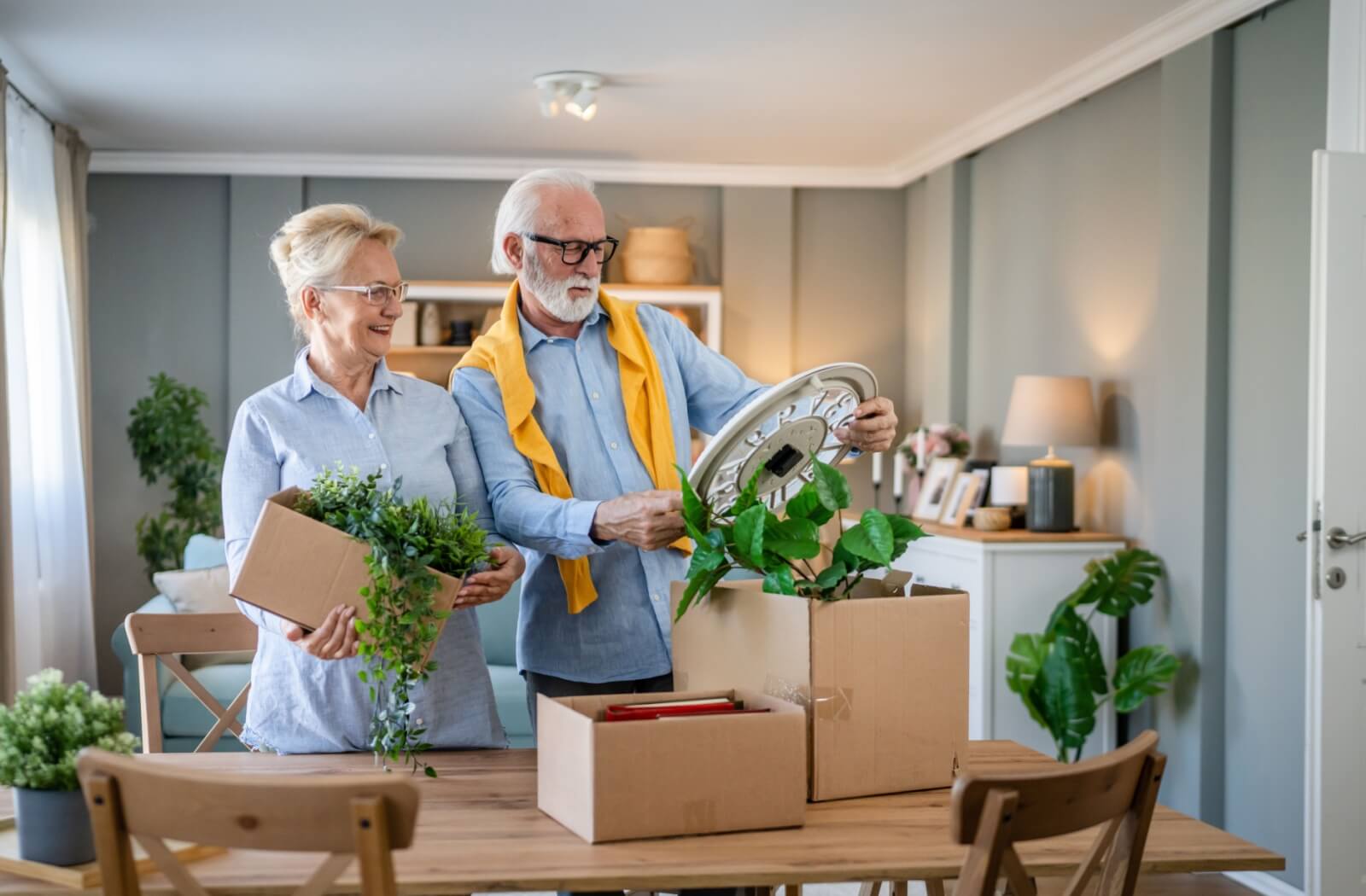 A senior couple sorts through their possessions to determine what should be kept for a move into assisted living